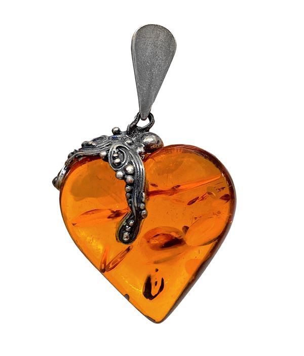 Silver pendant with amber heart