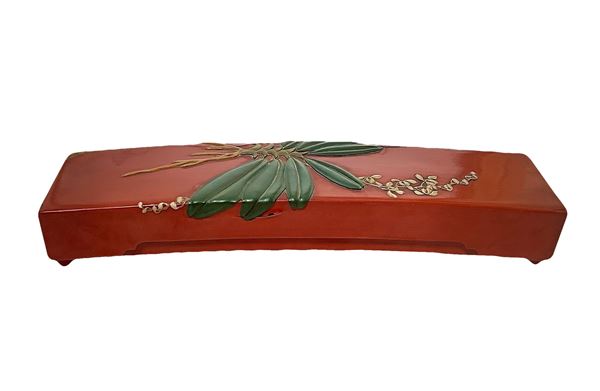 Lacquered storage box in orange tones.