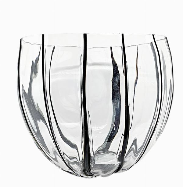 Irregularly rounded centerpiece with applied thin bands of black glass paste