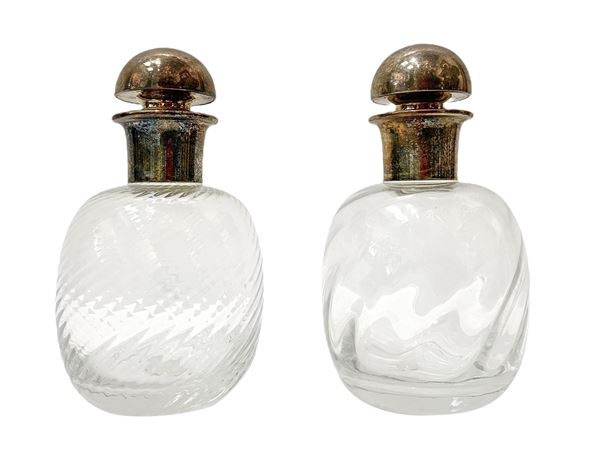 Pair of creased glass bottles with silver metal stopper