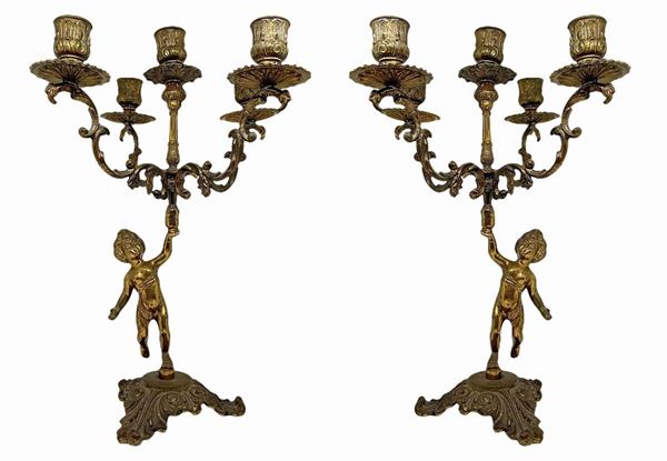 Pair of golden brass candlesticks with 5 lights supported by putto