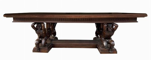 Exceptional neo-RenaisSaintce table in solid walnut wood, nineteenth century, with top supported by four sculptures depicting young cherubs, as Atlanteans supports. At the center of each side balustrades carved with grotesque elements. H cm 80x235x120.


