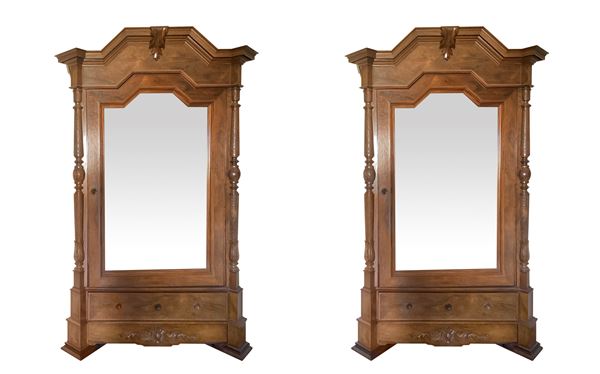 Pair of cabinets with mirror to one door.