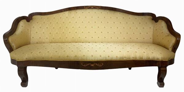 Sofa with central inlays at the base of the seat and back