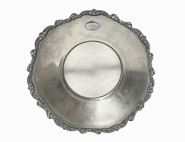 Small silver raised with leaf decorations on the edge