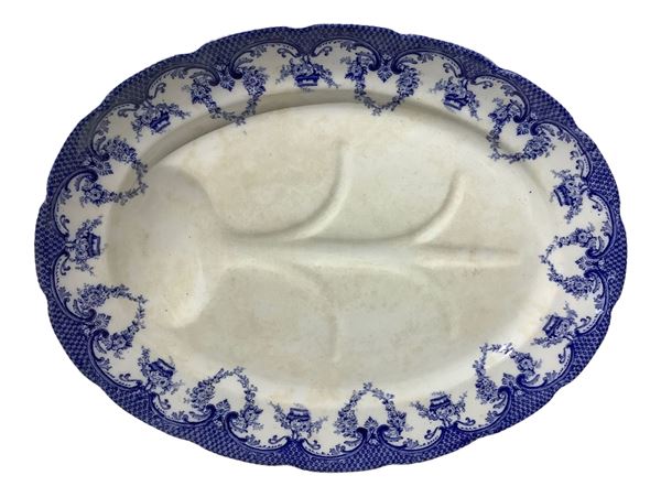 Oval porcelain plate with blue decorations on the edges