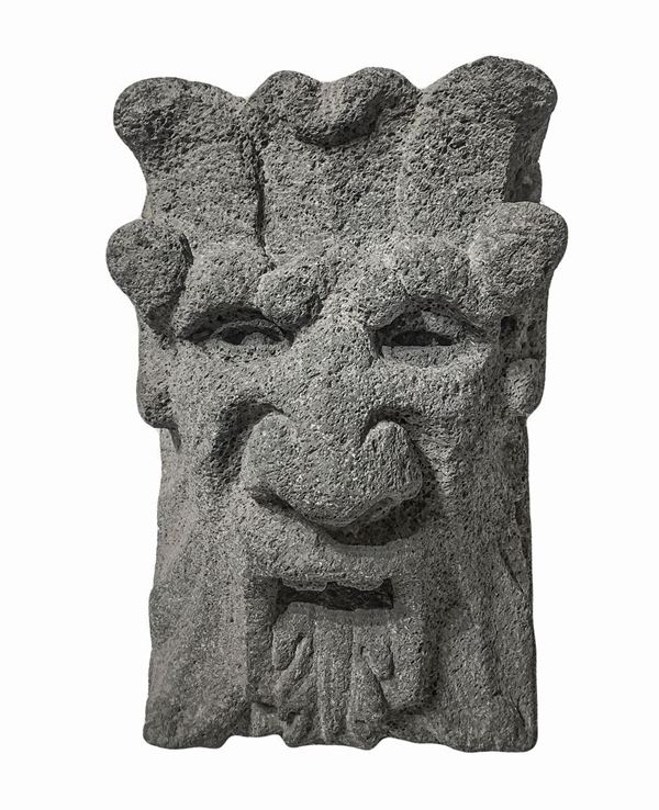 Lava stone key depicting mask