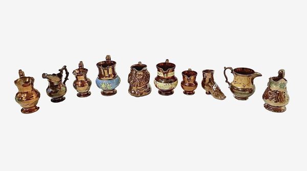 Group of maltese gilded glass jugs with polychrome decorations and a small jar in the shape of a maltese shoe in golden glass.