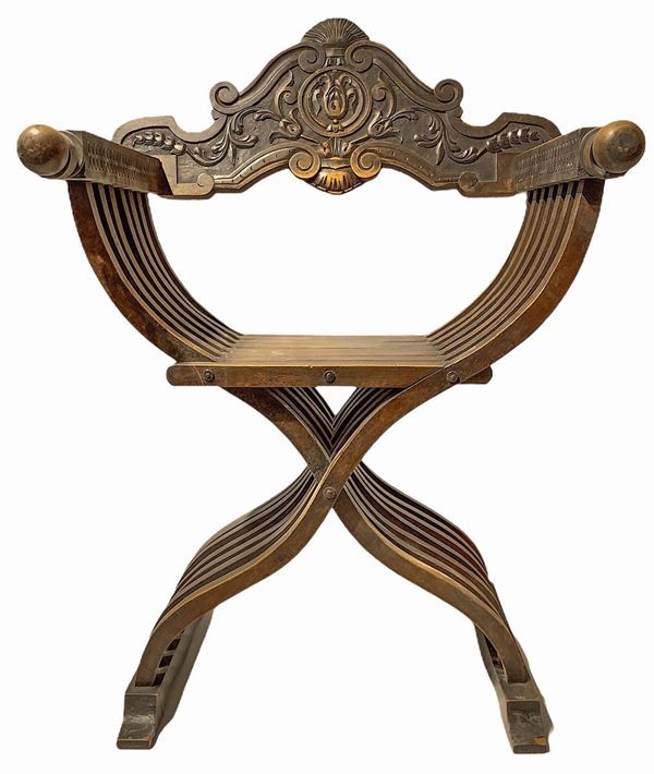 Savonarola chair with backpack and armrests.