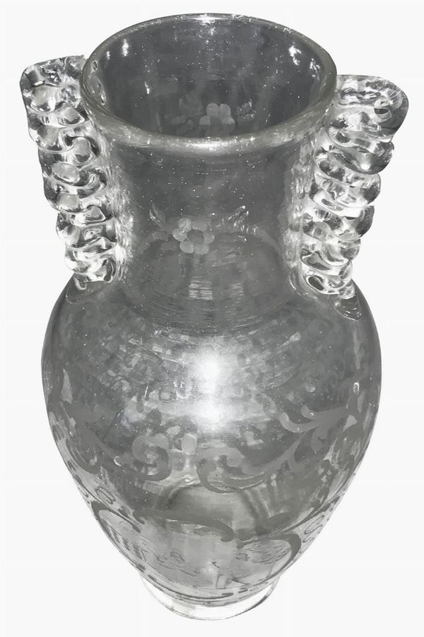 Toso iron. Years & lsquo 20. Transparent glass vase in the shape of a balustrade, a serpentine-shaped anse, grinding decoration depicting scene of ...
