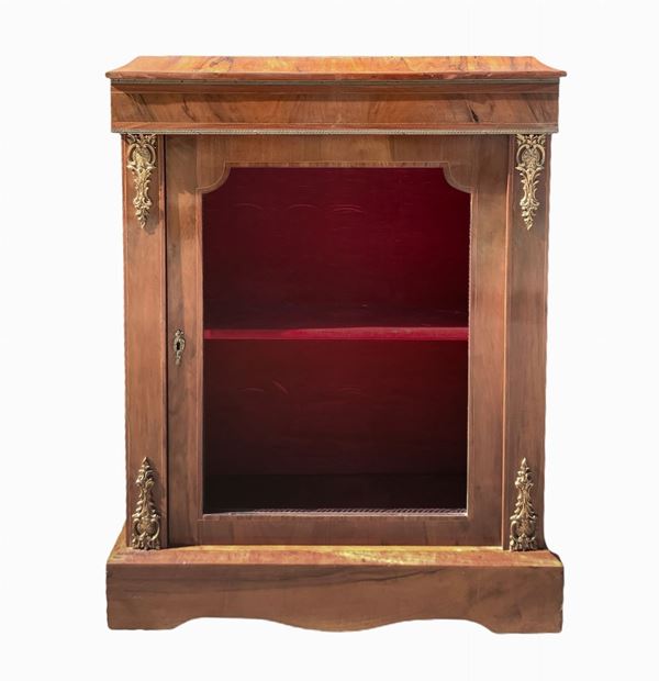 Showcase in walnut with bronze applications on the front