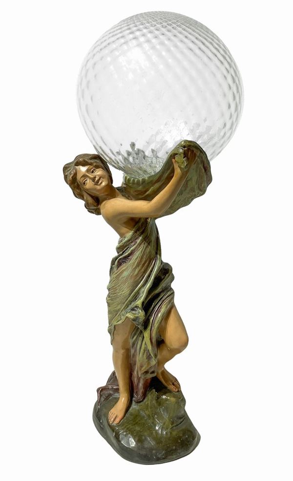 Lamp depicting a woman with a glass bowl