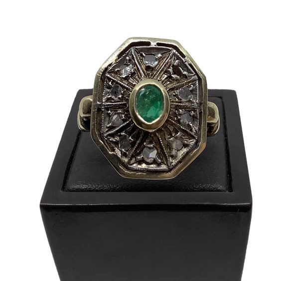Octagonal shaped ring in low title 12 carat gold with central emerald and diamonds