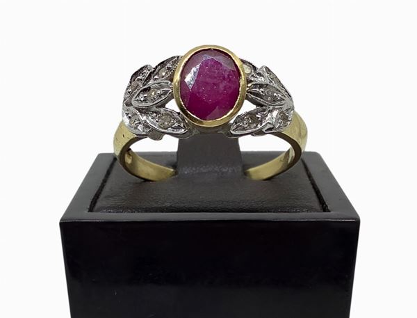 18 carat gold ring with oval ruby and ten 0,20 carat diamonds