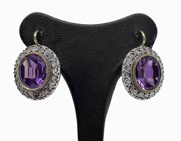 Earrings with faceted amethyst and ovals set with diamonds in 12 carat gold