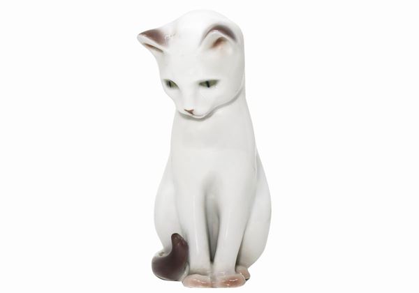 Porcelain figurine depicting a white cat