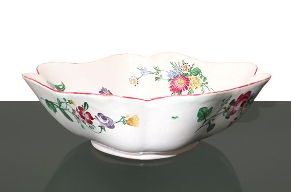 Porcelain centerpiece on a white background with flowers and a butterfly