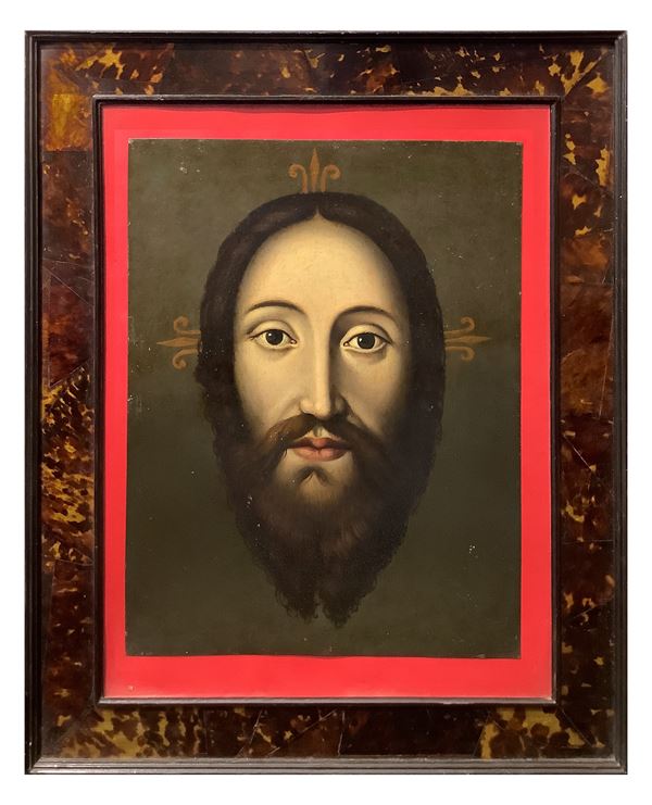 Painting depicting the face of Jesus in an antique turtle frame