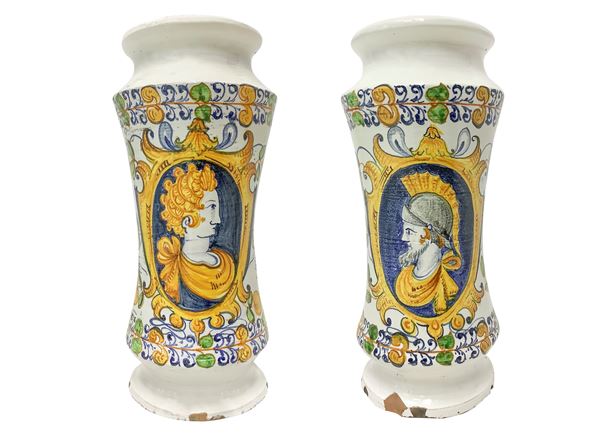 Pair of polychrome majolica albarelli with character on the front on a white base