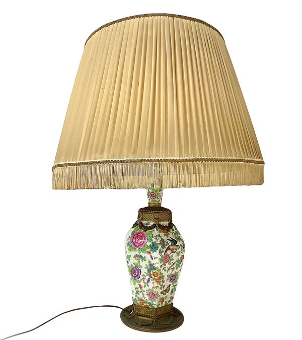 Porcelain table lamp painted with flowers and butterflies with gilded brass base