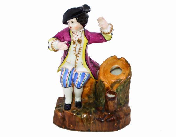 Figurine depicting a young man in period clothing