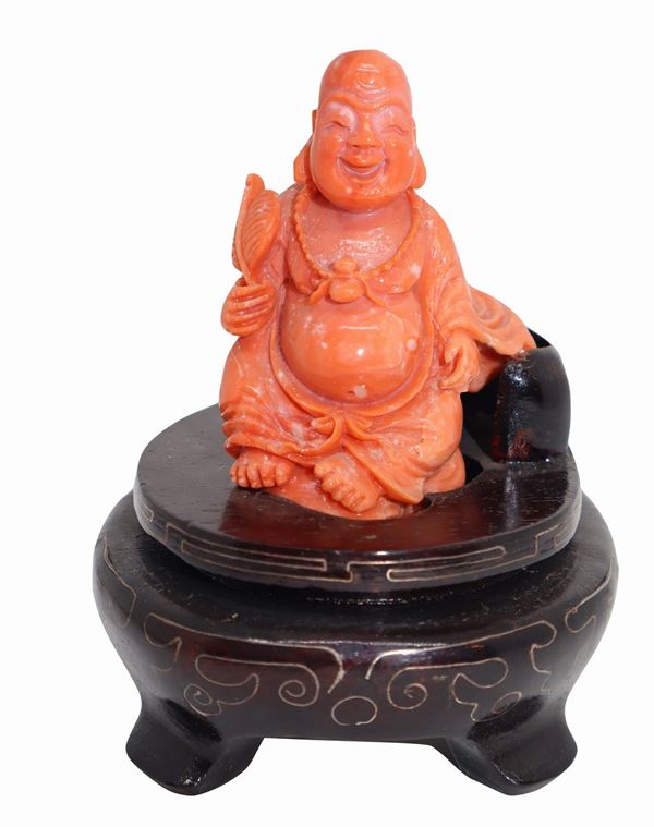 Laughing Buddha in coral