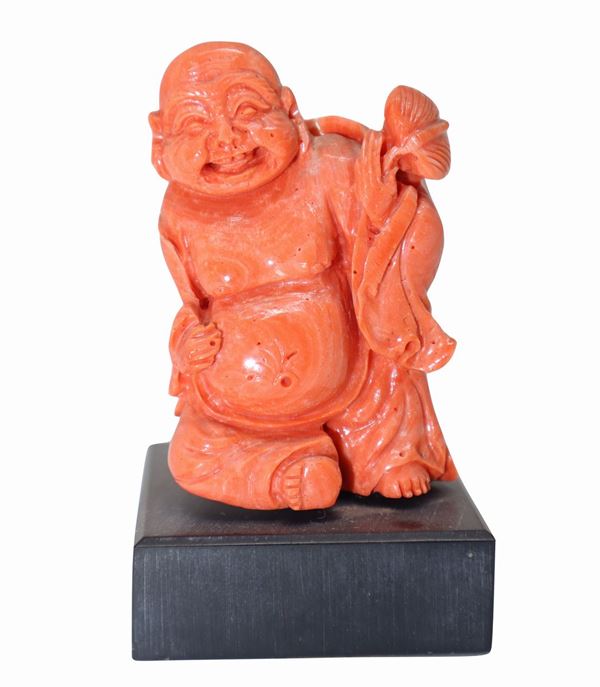 Buddha with coral lotus flower
