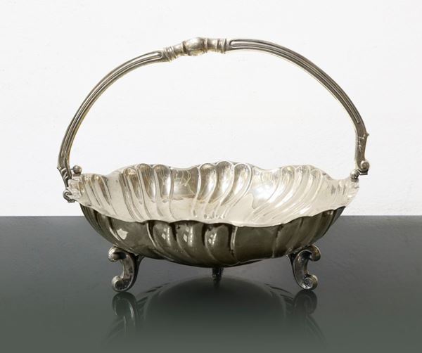 Stand with silver handle, scalloped basket shape.