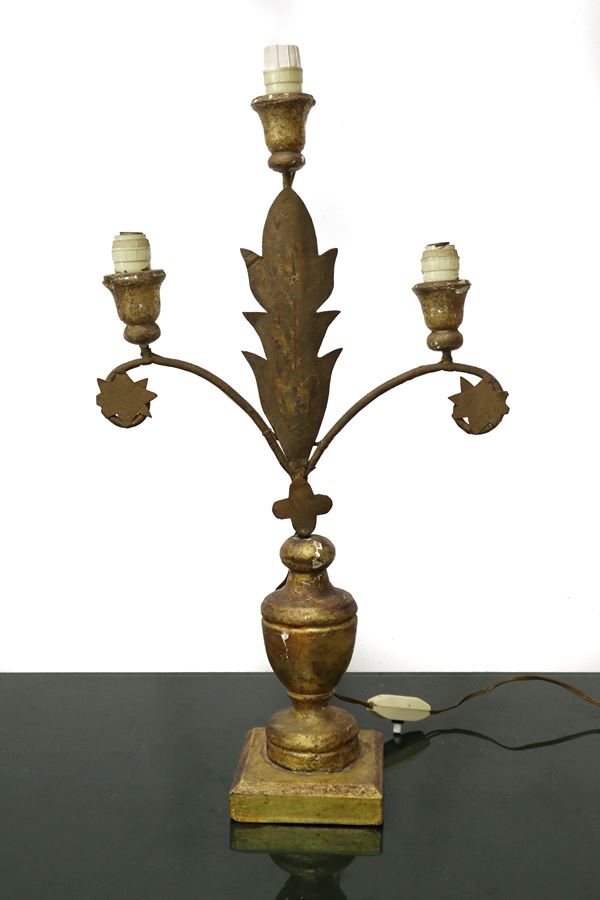 Golden wooden candlestick with three lights