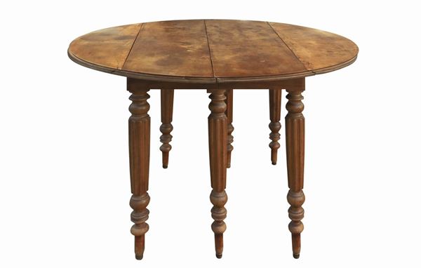 Round table in walnut wood with folding flaps