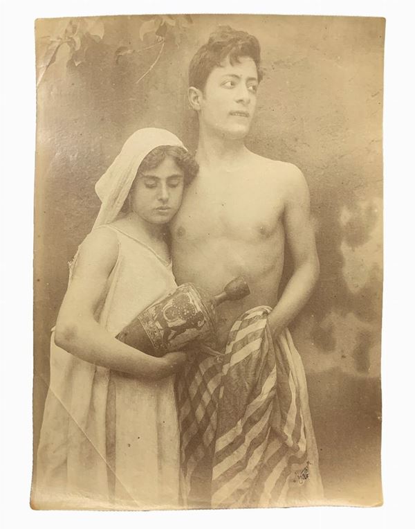 Wilhelm von Gloeden (1856-1931), albumin photos depicting teenage couple. Numbered 876 and hallmarked on the back. Cm 17x22

"Wilhelm Von Gloeden was a German-born photographer who spent most of his life in Sicily, specifically in Taormina, a city that he chose as a second home. It was the youth health issues to take in the peninsula. Specifically, the choice of Taormina is linked dreamy ideal of Sicily that the photographer releases in his pictures through the choice of models dressed as alwa