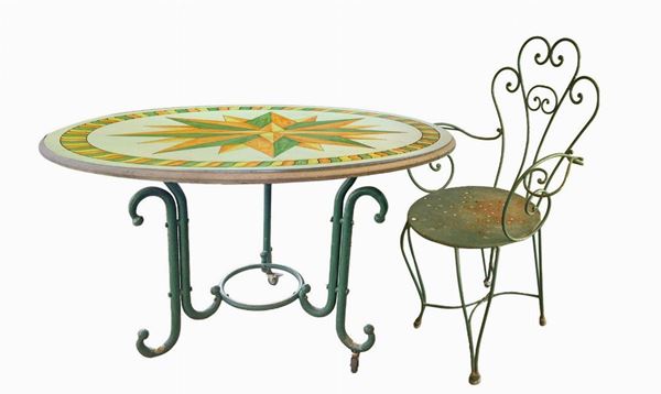 Round table in lava stone and 4 chairs. Decorated polychrome ceramic with twenty rose. Wrought iron supporting structure. Four chairs in ...