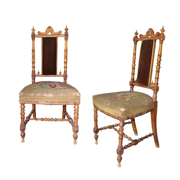 Pair of wooden chairs with college crests