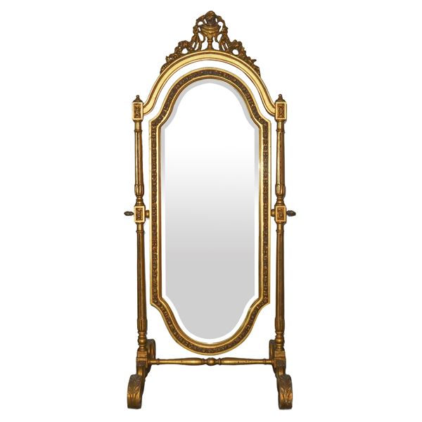 Shaped tilting mirror in gilded wood