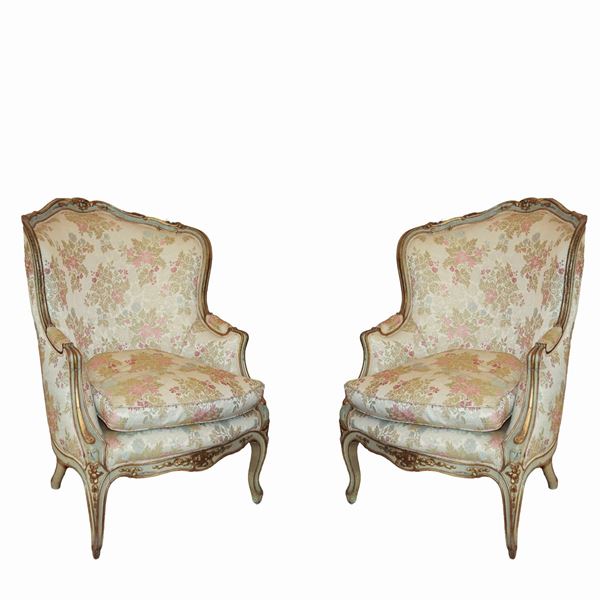 Antique pair of Louis XV armchairs. Finely carved and lacquered wood. Upholstered with floral motifs.
