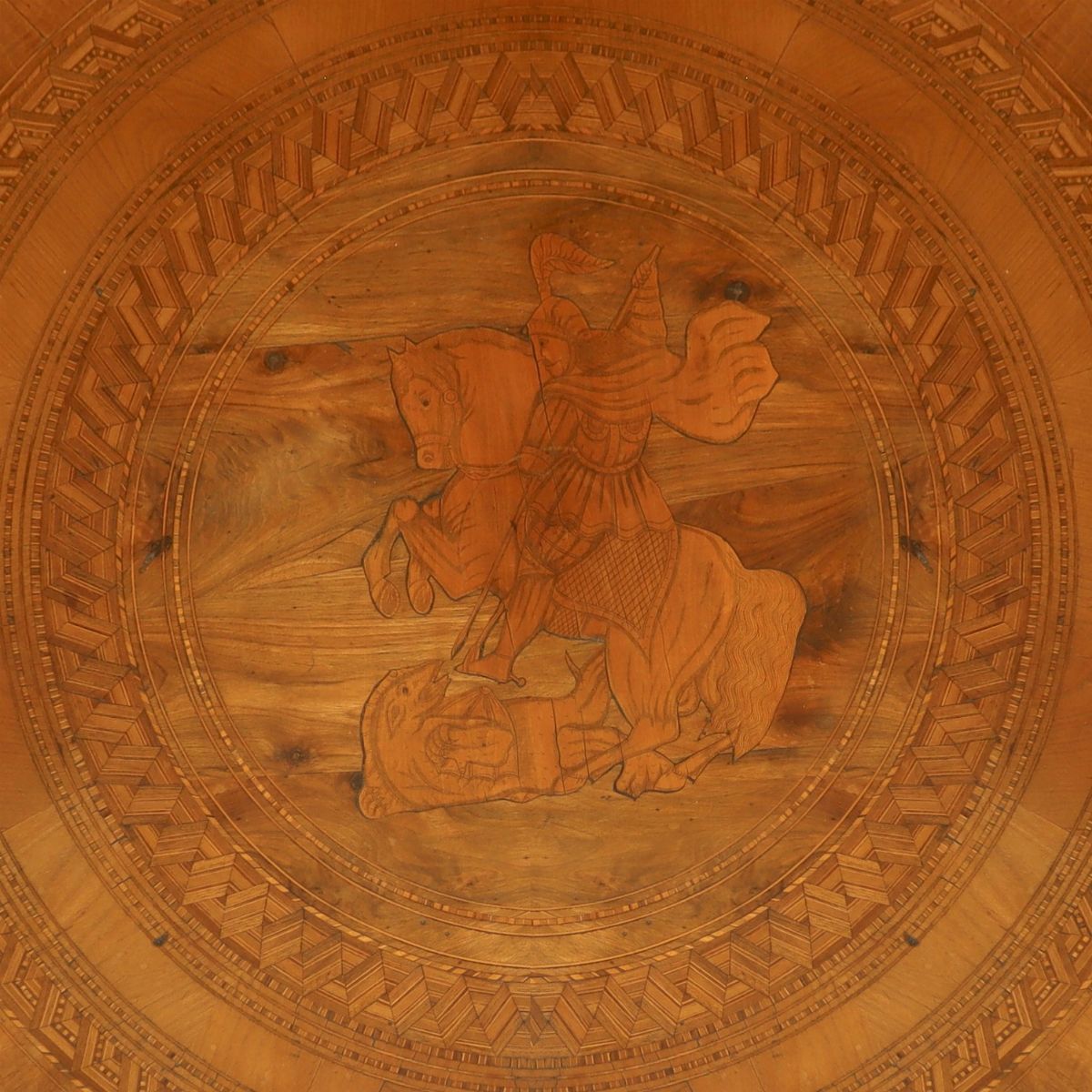 Tavolo rotondo, legno di noce, intarsio a motivi circolari con figura di San Giorgio e il Drago, ...