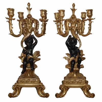 Coppia di candelabri in stile barocco, metallo dorato con putti laccati nero, a 5 luci
