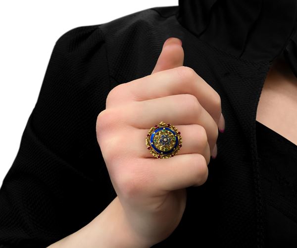 18kt gold ring with watch with rubies, emeralds, sapphires and central diamond