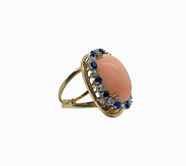 Yellow gold ring with pink coral Deep sea oval and round in white gold with diamonds and blue sapphires