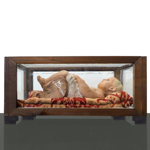 Little boy in polychrome ceramic from Caltagirone, in display case.