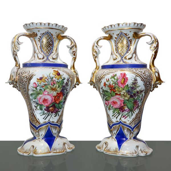 Pair of white porcelain vases with floral motifs and gold on the front and back.