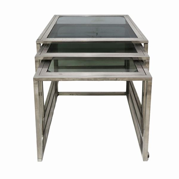 Set of N. 3 stackable tables in brushed steel.