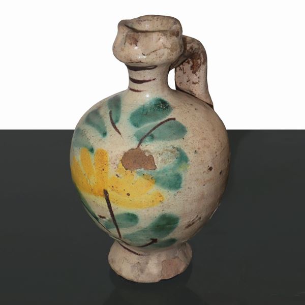 Small polychrome ceramic pourer from Caltagirone, glazed with flower and leaf decorations. Color drops