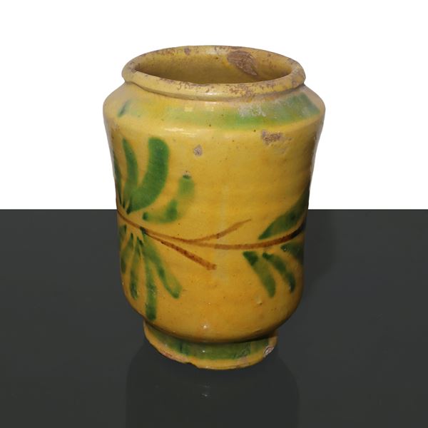 Caltagirone majolica cylinder, yellow glazed, with leaf decorations.