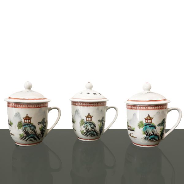 Three white porcelain herbal tea pots with depictions of landscapes