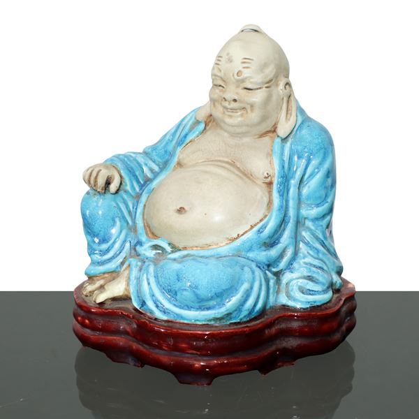 Laughing Pu-Tai Buddha in glazed ceramic in the colors of white and blue