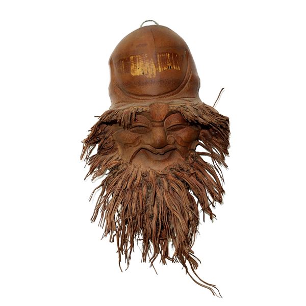 Face with beard carved in bamboo root