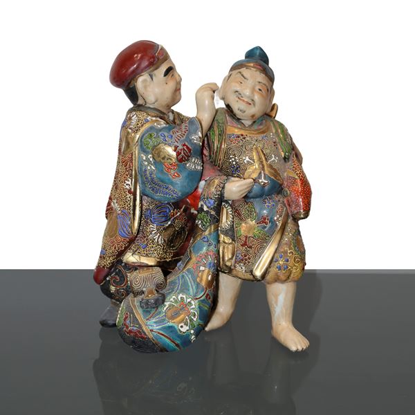 Pair of Japanese figurines with blue and gold enamelled details