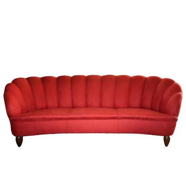 Red upholstered rounded sofa