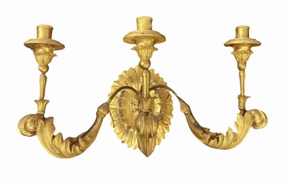 Applique in gilded wooden leafy, three flames. XVIII century. Base not contemporary. Base cm 30. Protuding part 45 cm width 56 cm